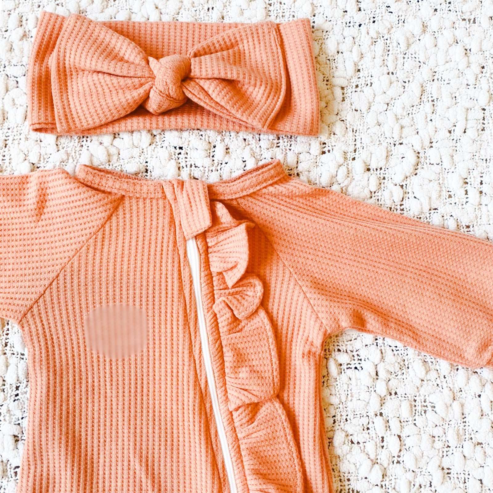 Peach waffle frill baby romper and headband.