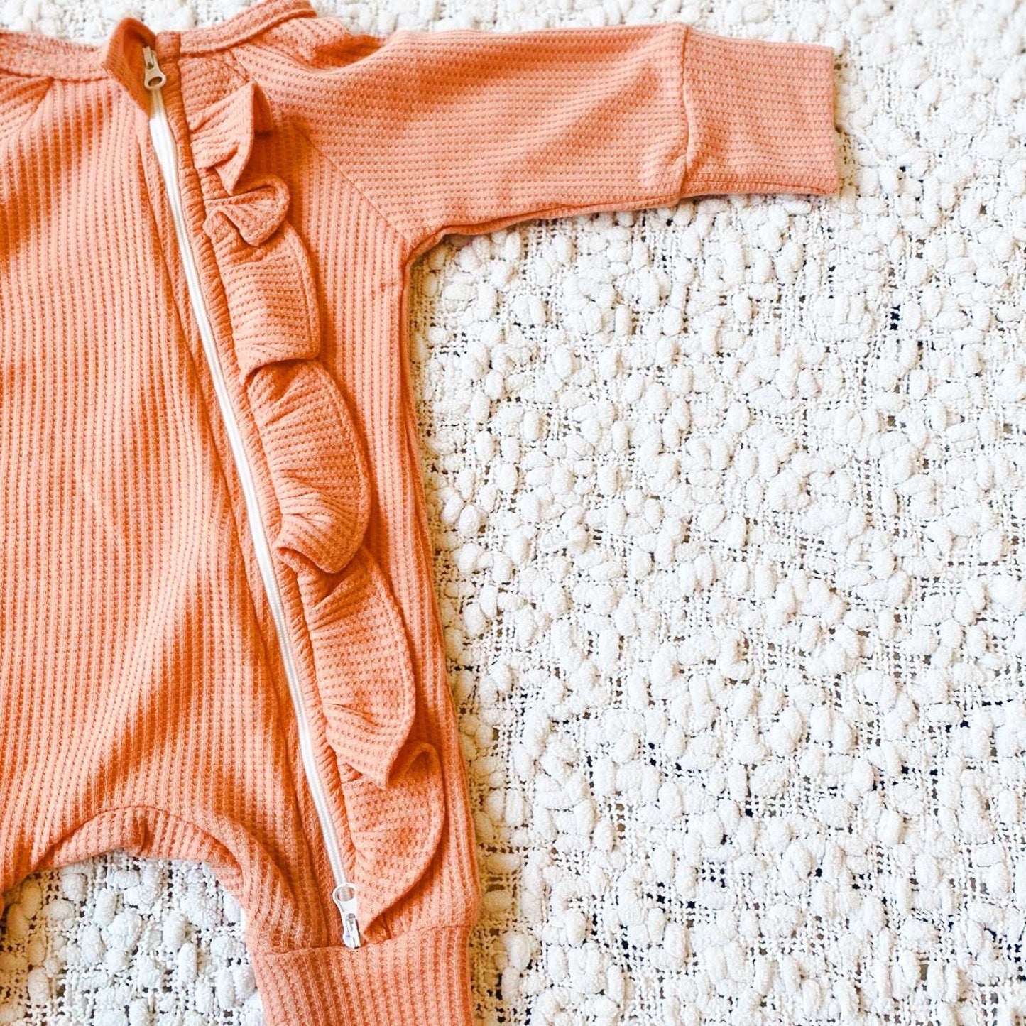 Peach waffle frill baby girl romper. Zip romper.